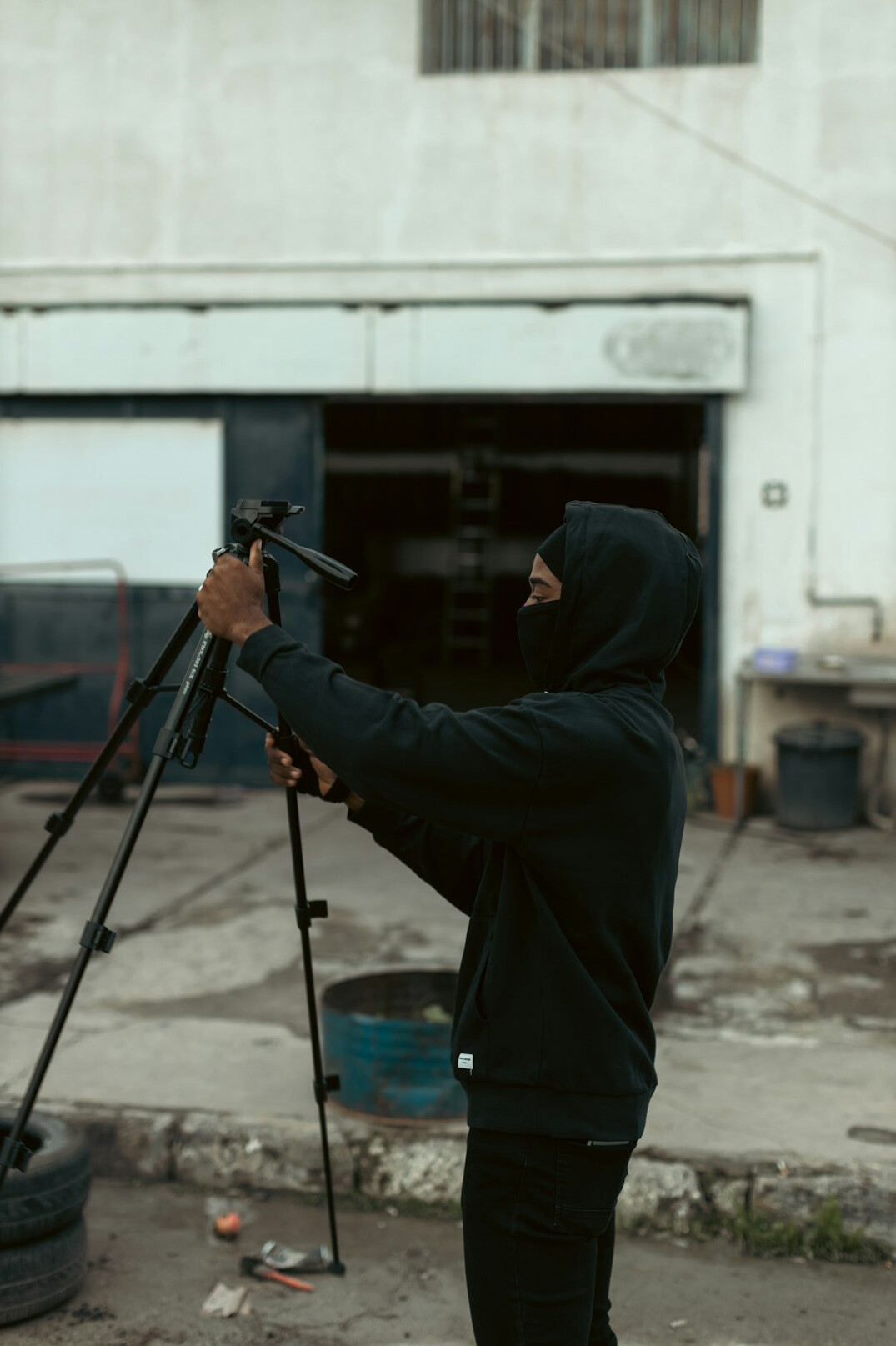 Technician adjusting a broadcast camera on a tripod